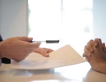 Closeup of two people discussing a document